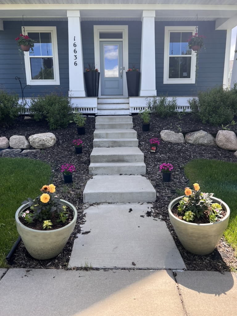 Front entrance of 16636 Eagleview Dr with covered porch and flower planters