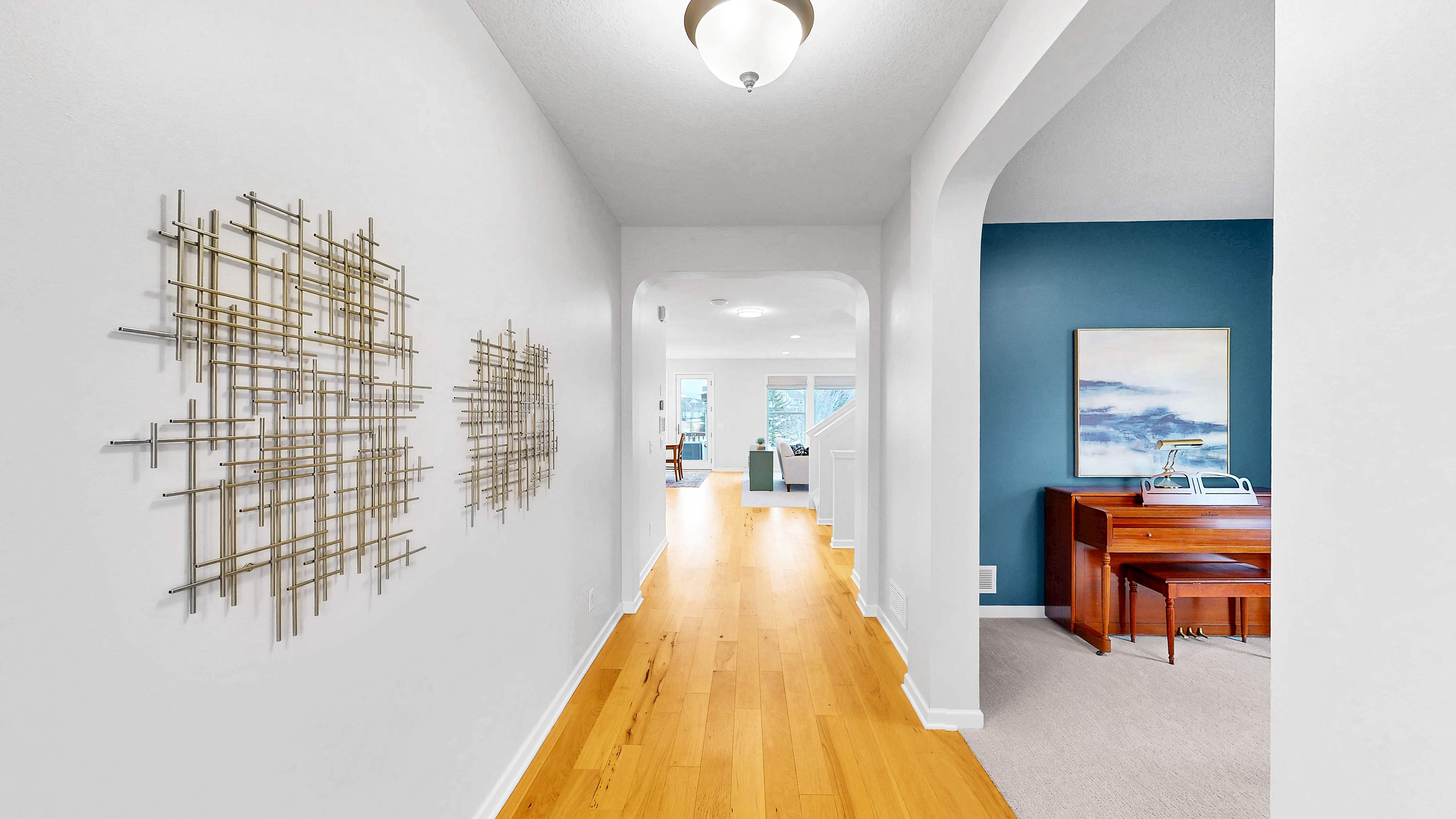 Entry hallway showing hickory hardwood floors and arched doorways